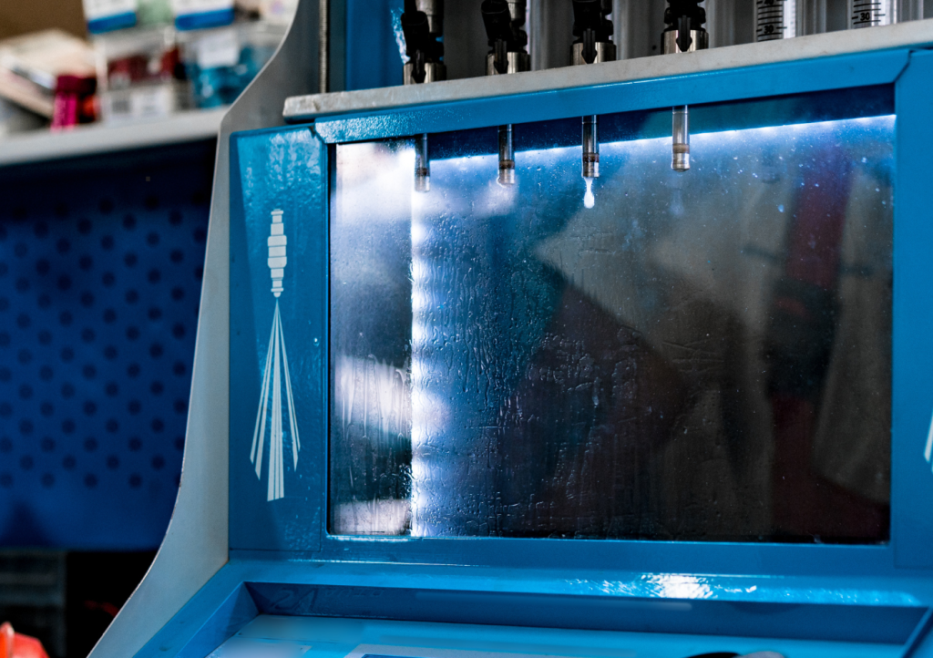 InjectorRX technician flow testing a set of restored fuel injectors